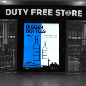 Lit up blue and white sign for Duty Free Shop at Pearson Airport