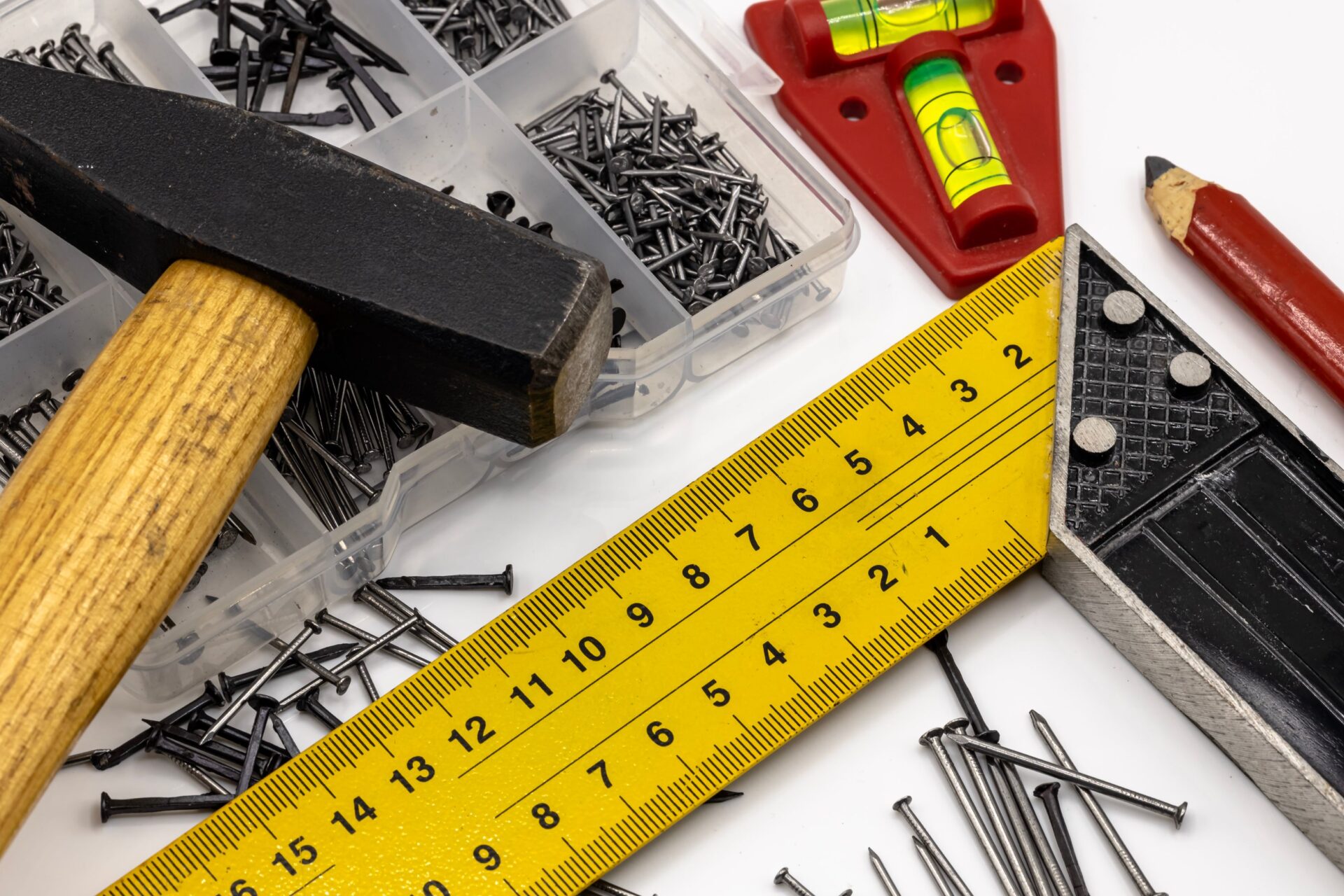 measuring tape, leveling tool, nails and hammer