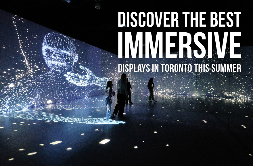 People standing in large room wit immersive screens in background