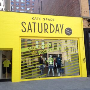 Bright yellow store front titled "Kate Spade Saturday" 