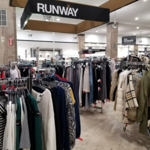 Winners lantern reading "RUNWAY" above clothing in store